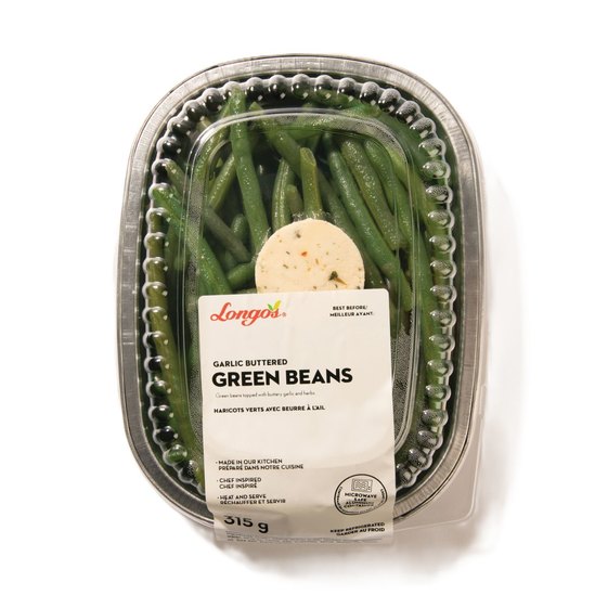 Longo's garlic buttered green beans in a refrigerated ready-to-heat meal tray with herb butter topping.